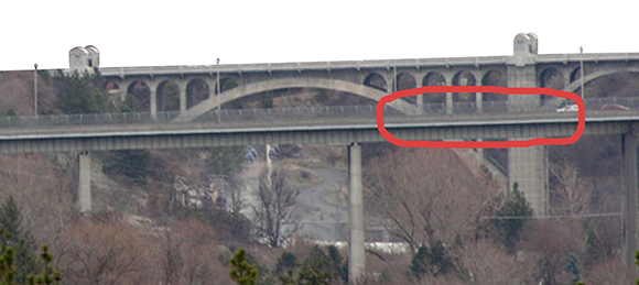 extracted section of bridge used in Christmas cover for Inland Register, diocesan Catholic newspaper for Spokane, Washington, showing Spokane cityscape with Lampshade Christmas tree and manger scene under bridge