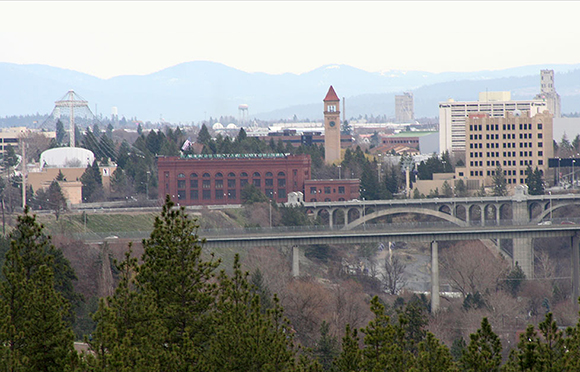photo of Spokane, WA which I used to create Christmas cover for Inland Register, diocesan Catholic newspaper for Spokane, Washington, showing Spokane cityscape with Lampshade Christmas tree and manger scene under bridge