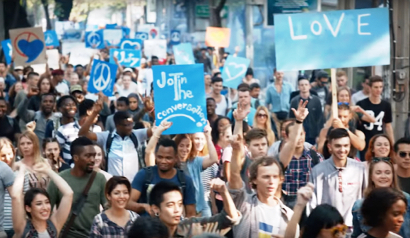 Kendall Jenner Pepsi ad generic happy protest marchers carrying bland signs peace love unity join the conversation