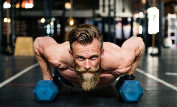 stock photo guy with blond beard working out at gym with weights doing pushups