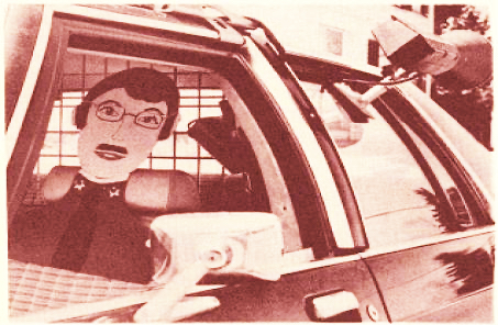 Captain Cardboard, a fake 2-dimensional policeman who sits in a police cruiser on Main Street in Marlborough, NH, to discourage speeders.